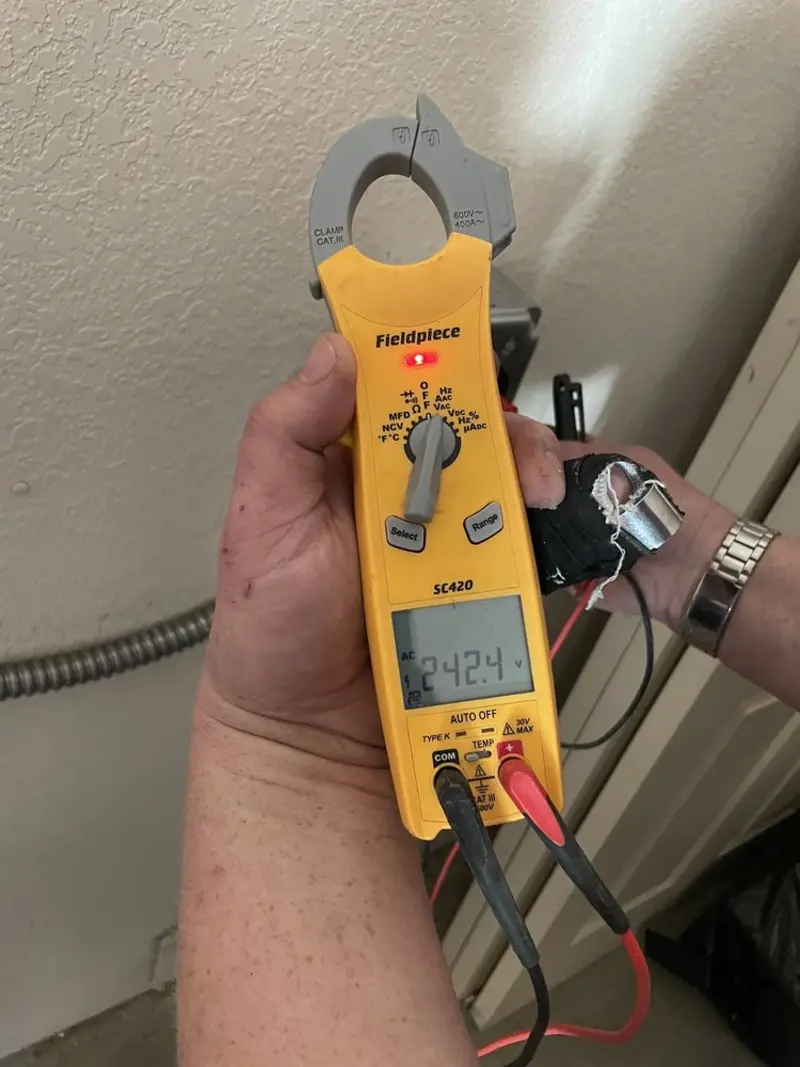 Voltage testing with clamp meter during Electrical Installation Services in Eaton